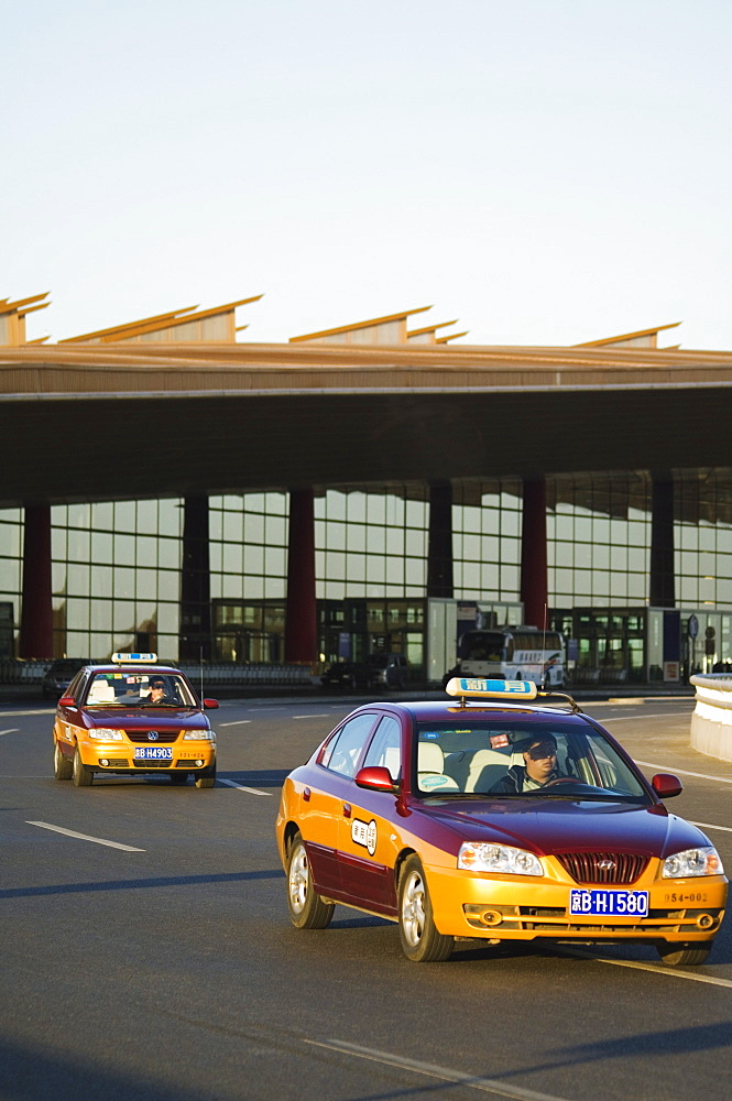 Taxis leaving Beijing Capital Airport part of new Terminal 3 building opened February 2008, second largest building in the world, Beijing, China, Asia