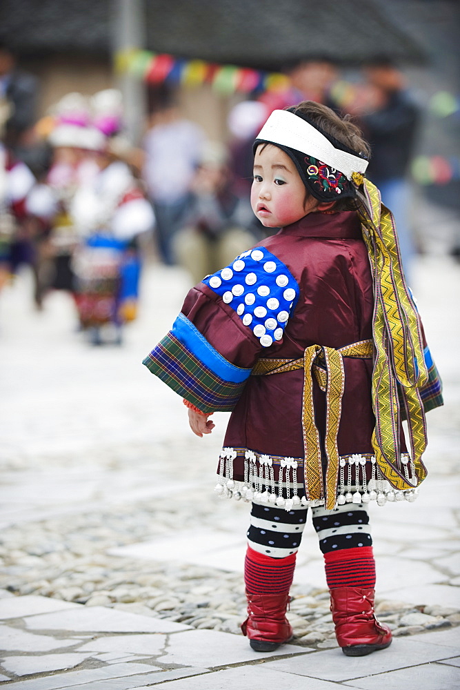 A girl in ethnic costume at a Lunar New Year festival in the Miao village of Qingman, Guizhou Province, China, Asia