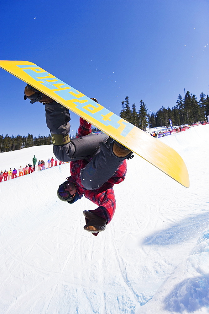 A snowboarder jumping at Telus Half Pipe competition 2009, Whistler mountain, 2010 Winter Olympics venue, British Columbia, Canada, North America