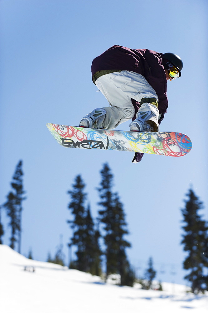 A snowboarder jumping at Telus Half Pipe competition 2009, Whistler mountain, 2010 Winter Olympics venue, British Columbia, Canada, North America