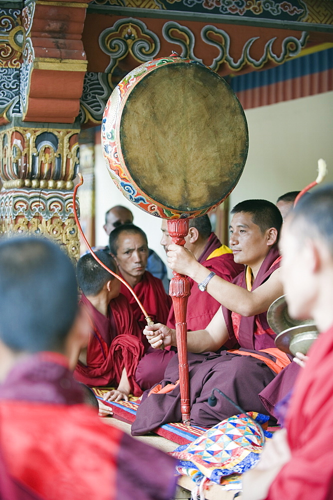 Monk with drum, Autumn Tsechu (festival) at Trashi Chhoe Dzong, Thimpu, Bhutan, Asia