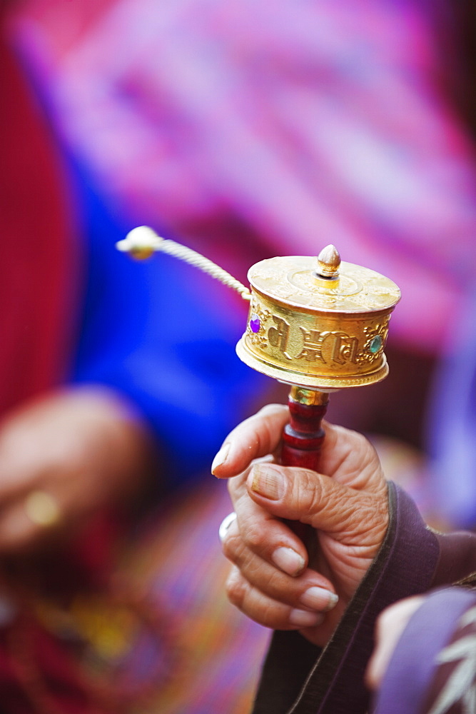 Prayer wheels being spun by a pilgrims at the National Memorial Chorten, Thimphu, Bhutan, Asia