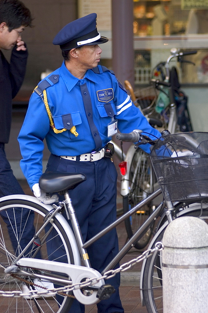 Policeman with bicycle, Kyoto city, Honshu, Japan, Asia