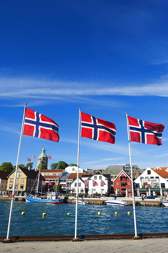 Norwegian flags and historic harbour warehouses, Stavanger, Norway, Scandinavia, Europe