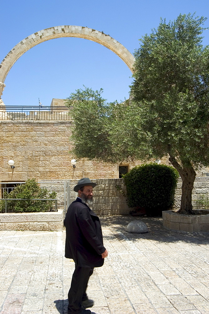 Jewish man in traditional clothes in front of the Hurva Synagogue arch, Old Walled City, Jerusalem, Israel, Middle East