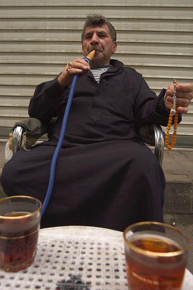 Man smoking water pipe, Aleppo (Haleb), Syria, Middle East