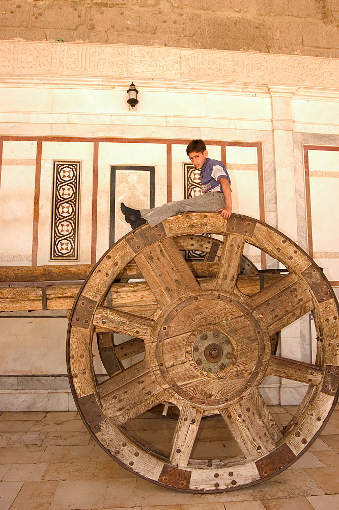 Boy on top of big wheeled cart, Umayyad Mosque, Damascus, Syria, Middle East