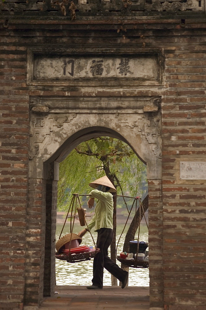 Lady carrying baskets, Hoan Kiem Lake, Hanoi, Northern Vietnam, Southeast Asia, Asia