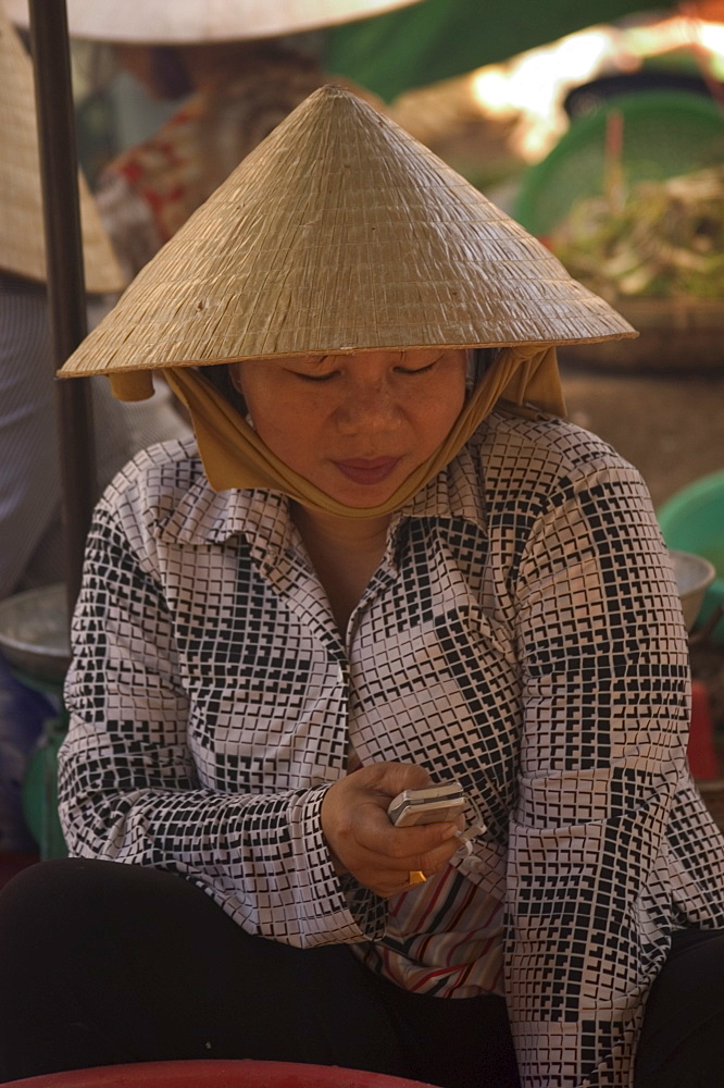 Woman wearing conical hat, Binh Tay market, Ho Chi Minh City (Saigon), Vietnam, Southeast Asia, Asia