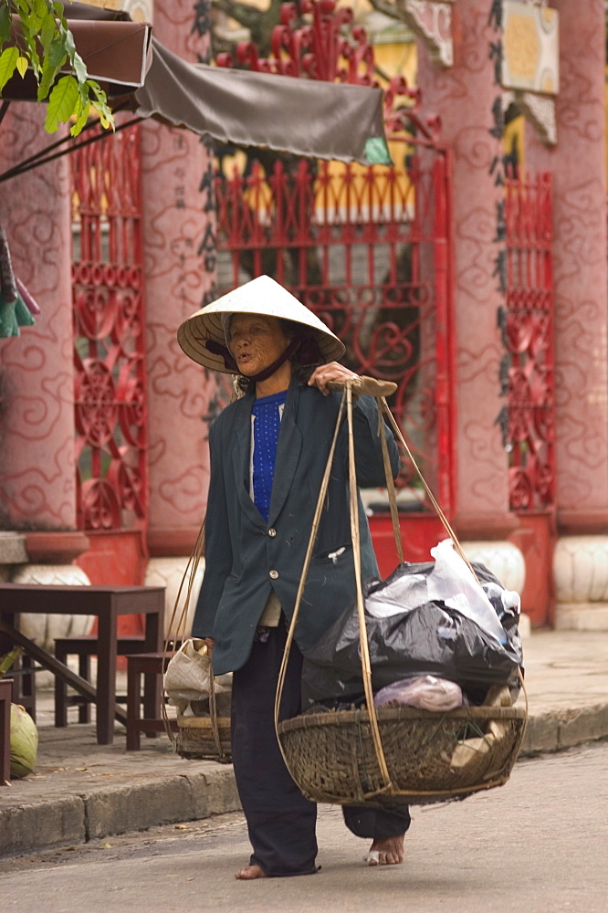 Woman with basket, Hoi An, Vietnam, Southeast Asia, Asia