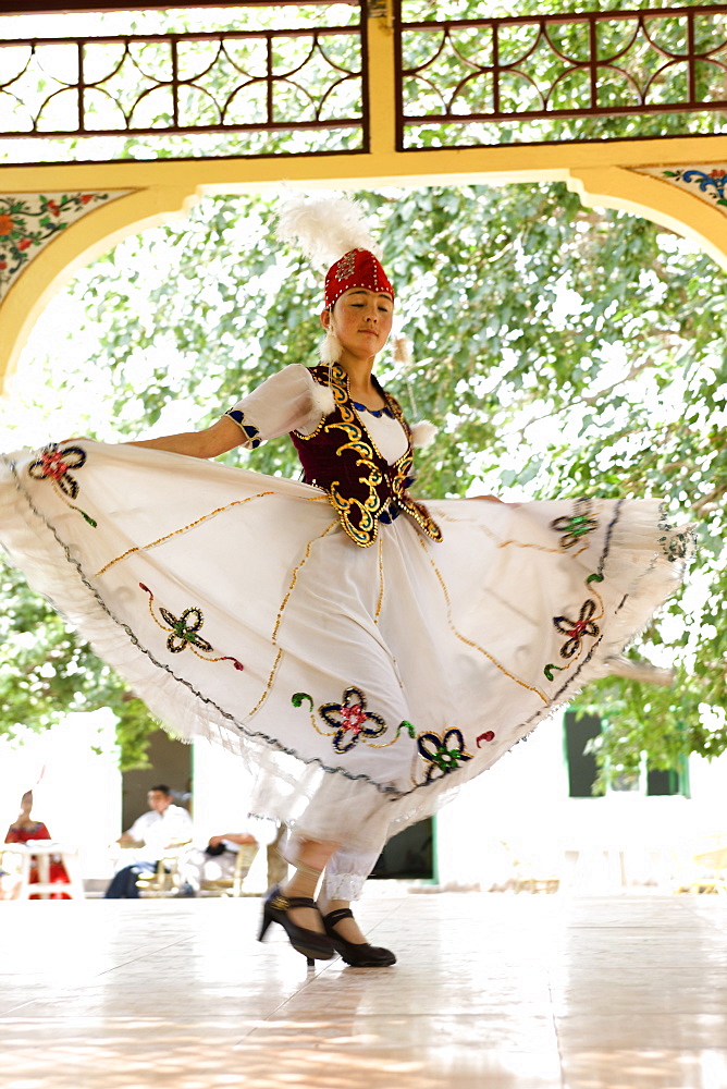 An Uyghur dancer performing dance in Abakh Hoja Tomb, Kashgar, Xinjiang Uyghur autonomy district, Silkroad, China