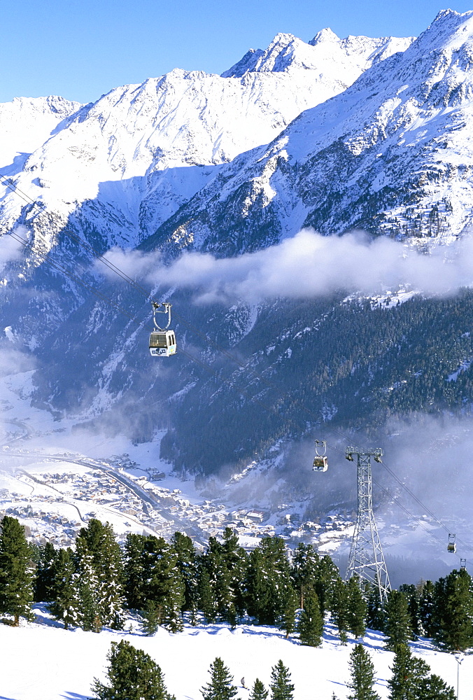 Gondolas rising above village of Solden in Tirol Alps, Tirol, Austria, Europe