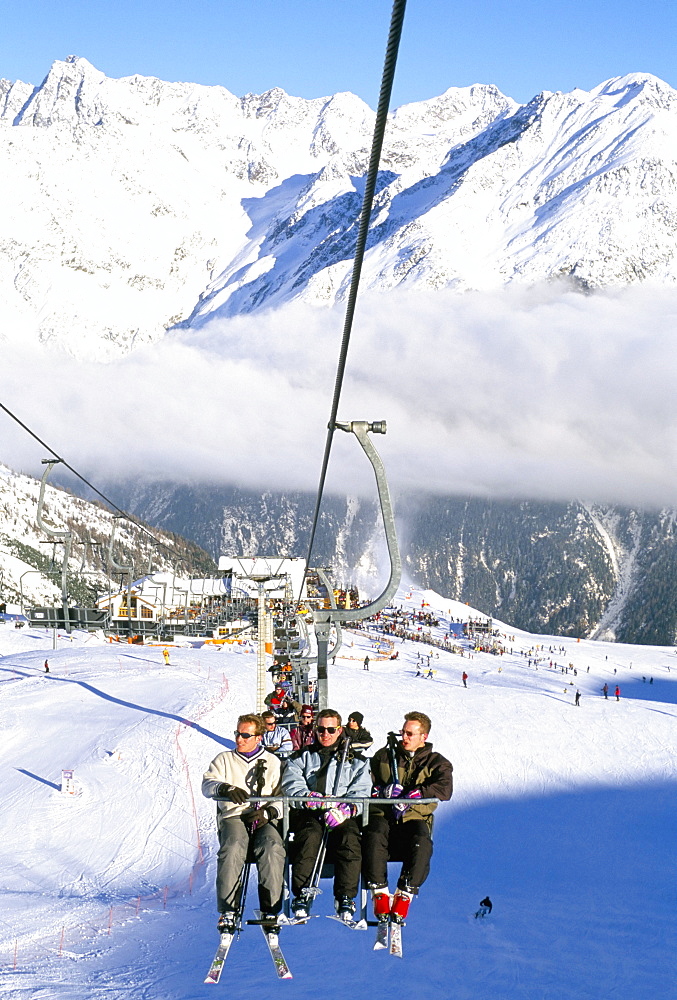 Skiers riding chairlift up to slopes from village of Solden, Tirol Alps, Tirol, Austria, Europe