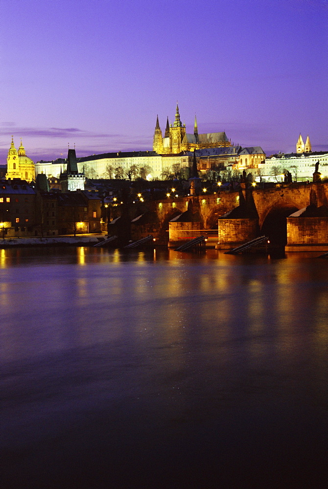 Charles Bridge, Vltava River, Mala Strana and Prague Castle at twilight during winter, Mala Strana, Prague, Czech Republic, Europe