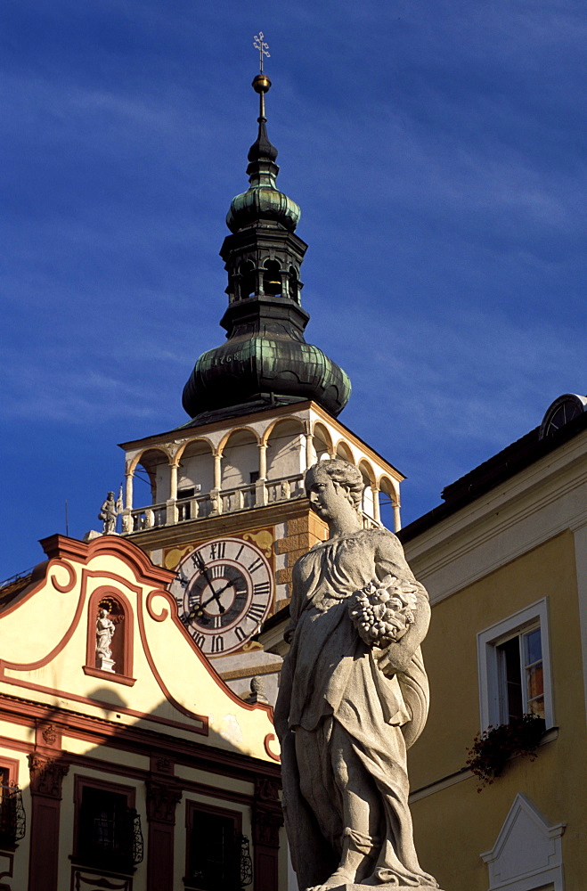 Close-up of statue on Nemesti and church clock tower of Mikulov, Mikulovska wine region, Mikulov, Brno Region, Czech Republic, Europe