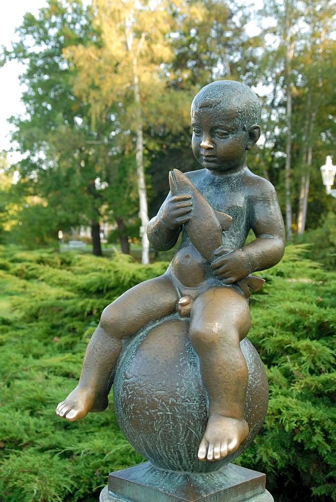 Statue of well-known boy holding a fish at spa Park of Solni and Lucni Spring in the spa town of Frantiskovy Lazne, Karlovarsky Region, West Bohemia, Czech Republic, Europe