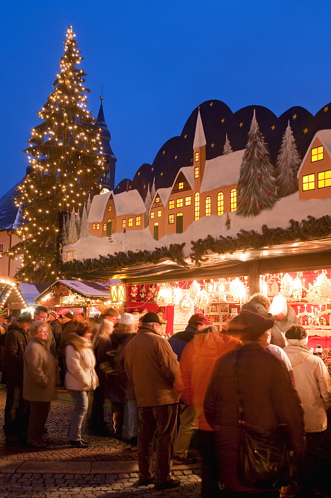 Christmas Market with decorated stall, people and Christmas tree at twilight, Markt Square, Annaberg-Bucholz, Saxony, Germany, Europe