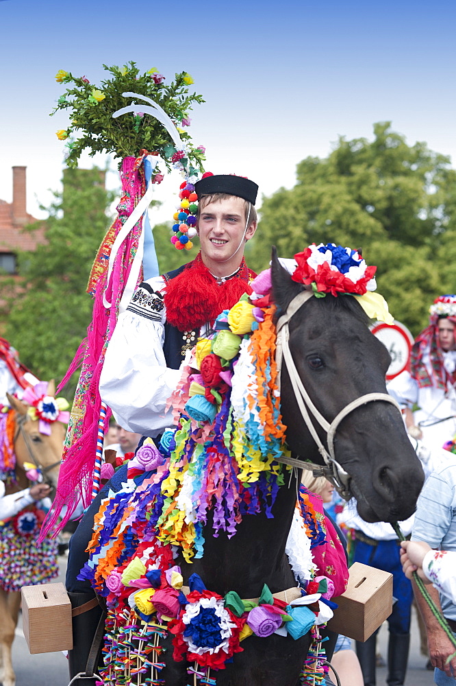 Man riding horse and wearing folk dress during festival Ride of the Kings, Vlcnov, Zlinsko, Czech Republic, Europe