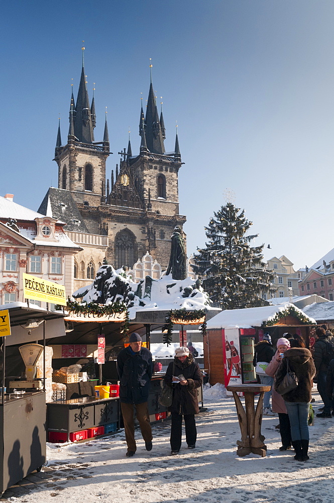 Snow-covered Christmas Market and Tyn Church, Old Town Square, Prague, Czech Republic, Europe