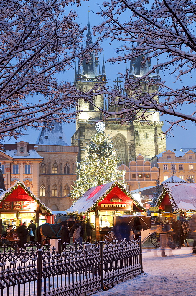 Snow-covered Christmas Market and Tyn Church, Old Town Square, Prague, Czech Republic, Europe