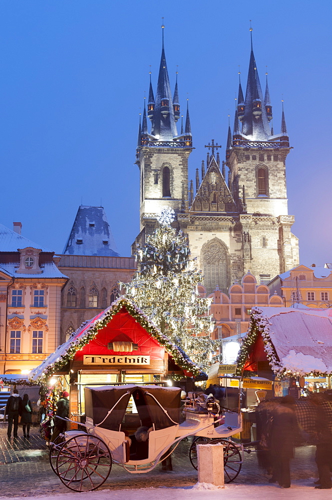 Snow-covered Christmas Market and Tyn Church, Old Town Square, Prague, Czech Republic, Europe