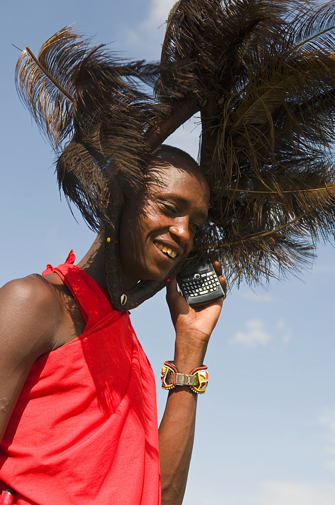 Masai man talking on mobile phone, Masai Mara, Kenya, East Africa, Africa