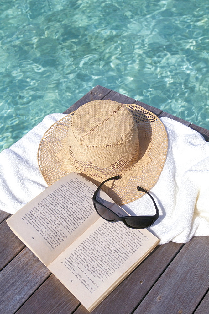 Straw hat, book and sunglasses on towel, North Male Atoll, Maldives, Indian Ocean, Asia