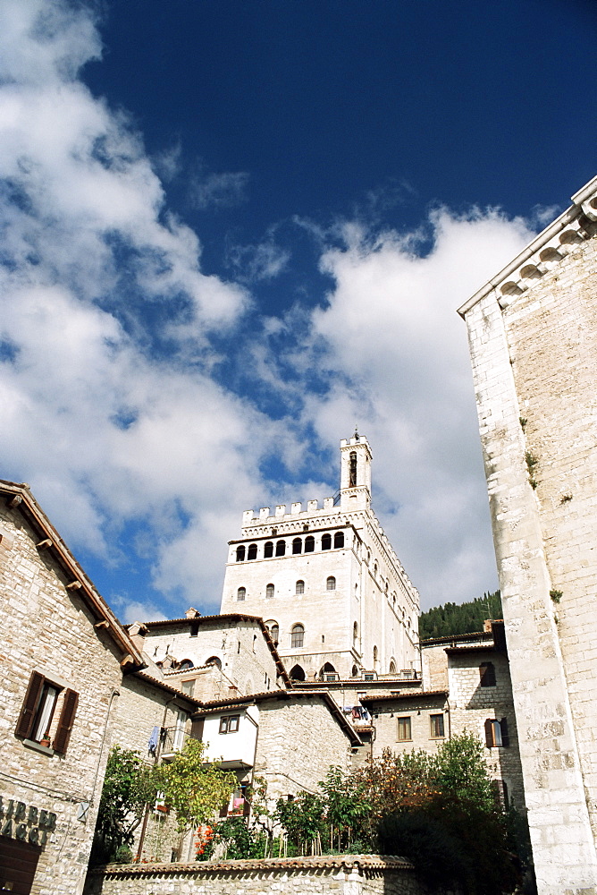 Buildings in the town with Palazzo dei Consoli in the background, Gubbio, Umbria, Italy, Europe