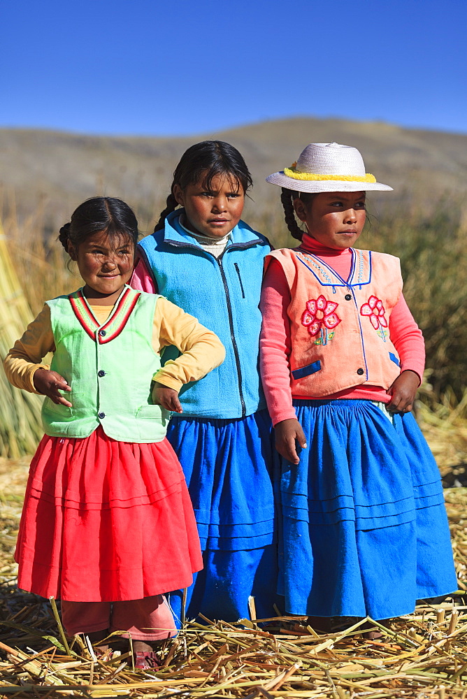 Children leaving on the Uros floating islands on Lake Titicaca, Puno, Peru