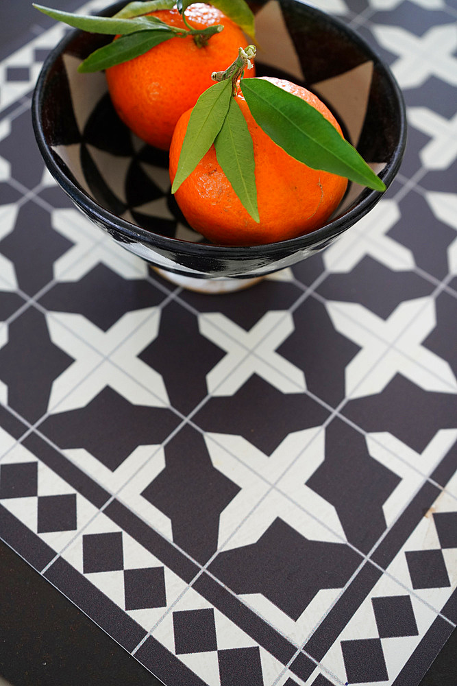 Tangerine in a bowl on squared background, Italy, Europe