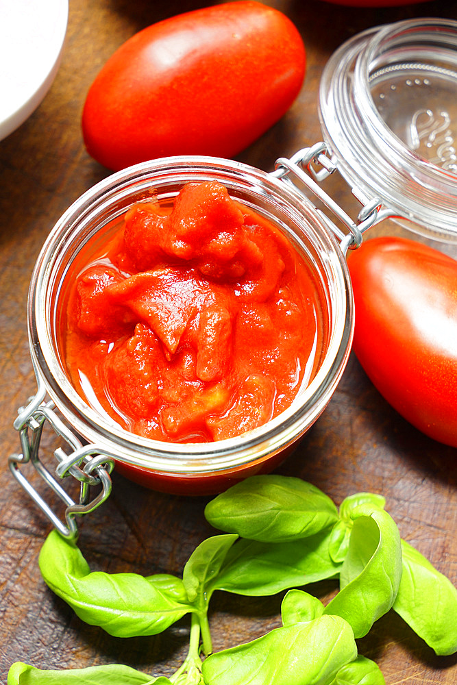 Home preparation of tomato sauce with fresh basil, Italy, Europe