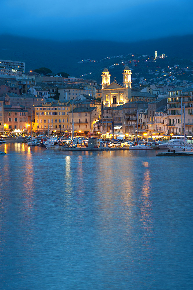 Marina in front of the church Eglise Saint Jean Baptiste at dusk, Corsica, France, Europe