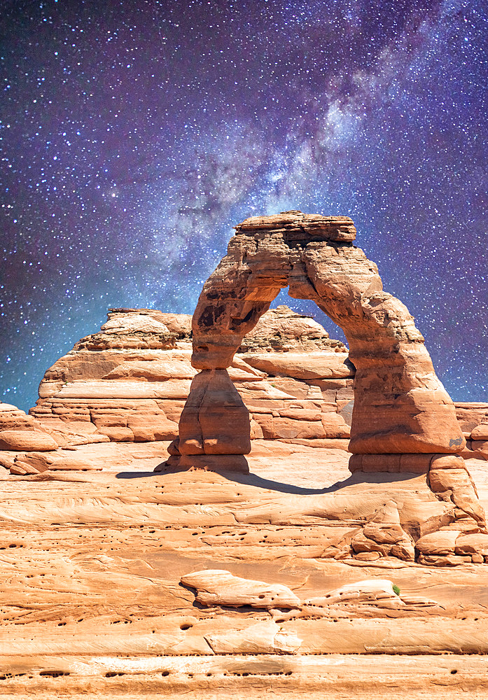 Delicate Arch as seen from lower point of view with milky way at night, Arches National Park, UT.