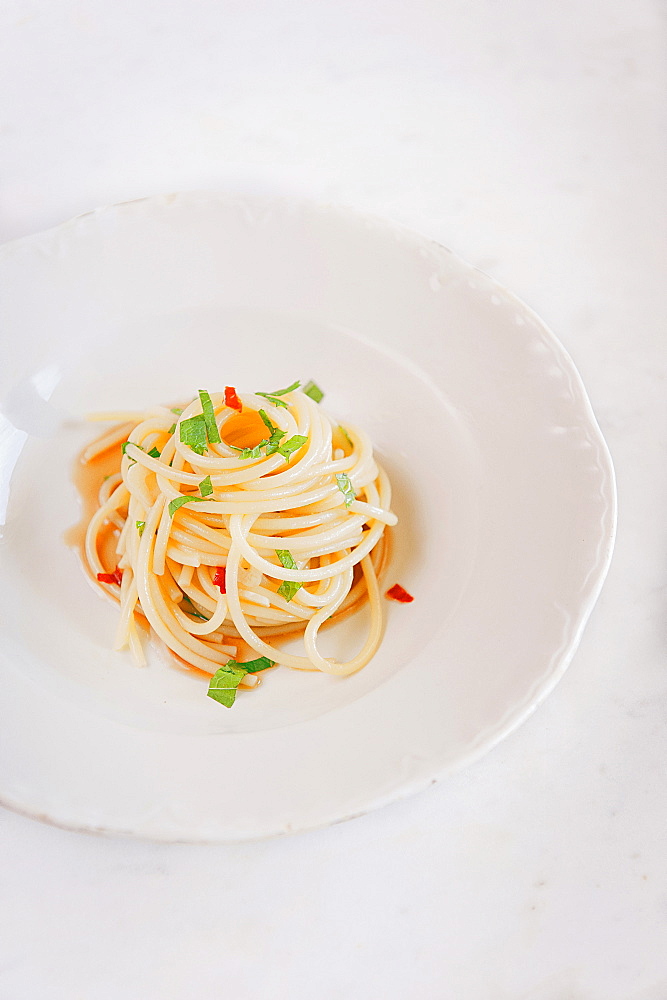 Spaghetti pasta with anchovy sauce, Colatura, parsley and fresh chilli. Cetara, Amalfi Coast, Campania, Italy; Europe