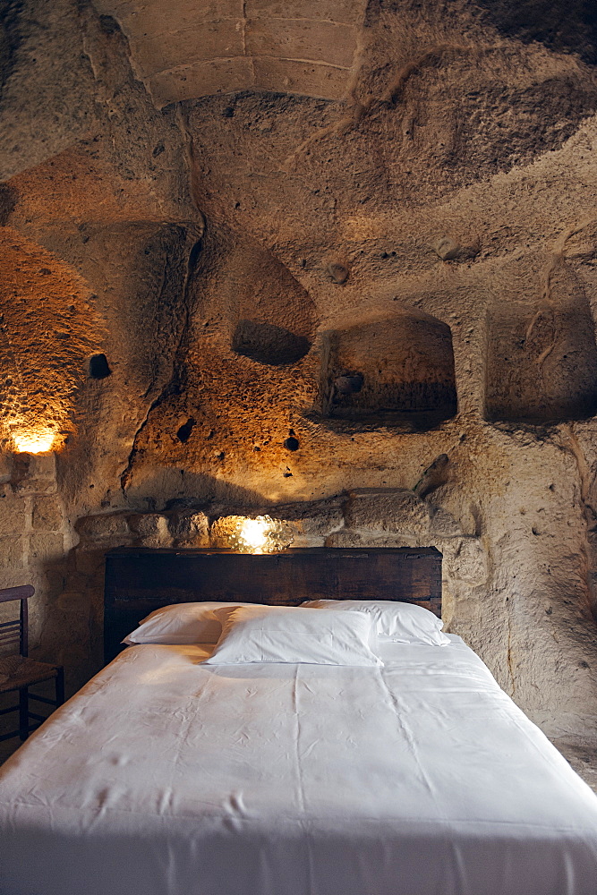 Bedroom of the hotel Le Grotte della Civita located in the Sassi di Matera that represents the almost paradigmatic expression of the Minor Historical Heritage, Matera, Basilicata, Italy, Europe