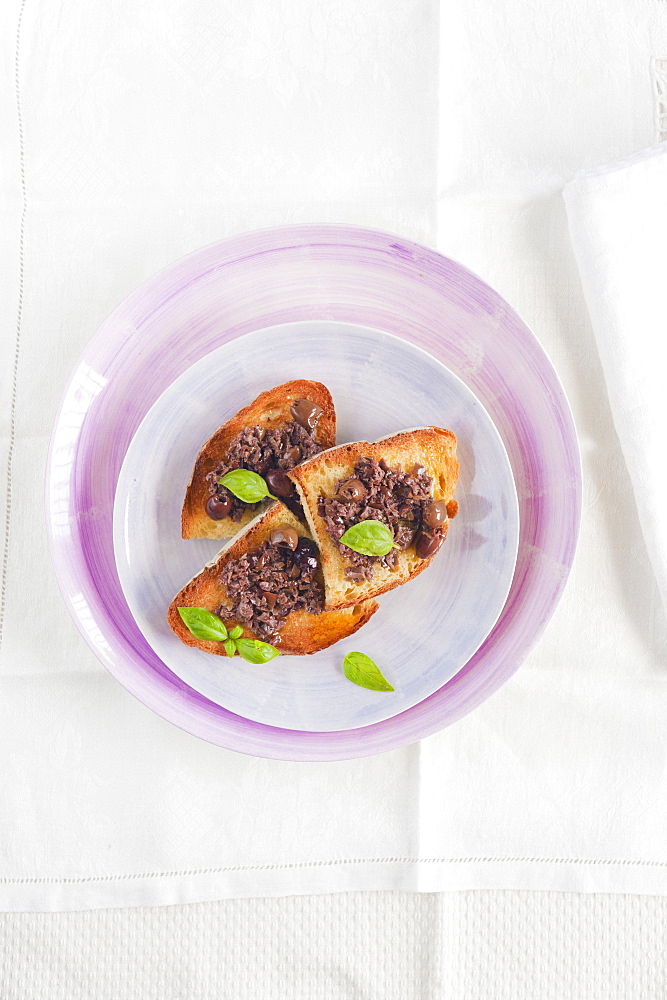 Olive tapenade on crusty homemade bread. Port Grimaud, Provence, France.