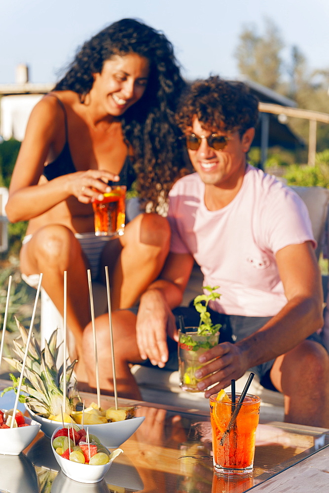 Girls and boys at sunset toast with an aperitif, EcoVillage Maremirtilli, Capaccio Paestum, Campania, Italy, Europe