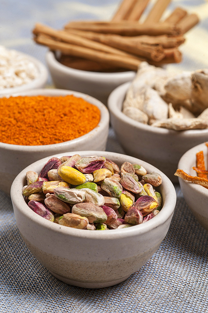 Assorted seeds and flavors on a grey cloth.