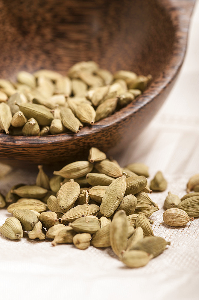 Cardamom seeds in a small timber bowl