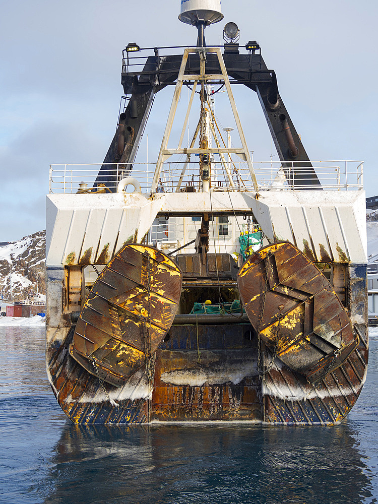 Otter boards. Trawler Lomur run by Royal Greenland. Winter in the frozen harbour of town Ilulissat on the shore of Disko Bay. America, North America, Greenland, Denmark