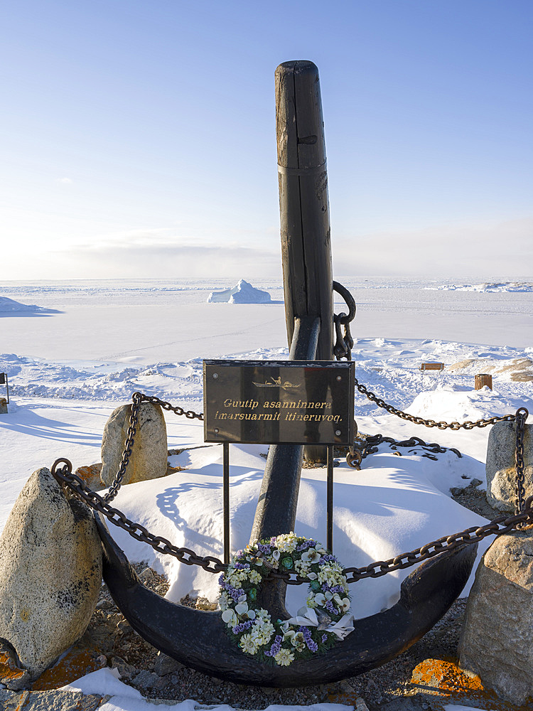 Monument with an anchor. Winter in Ilulissat on the shore of Disko Bay. America, North America, Greenland, Denmark