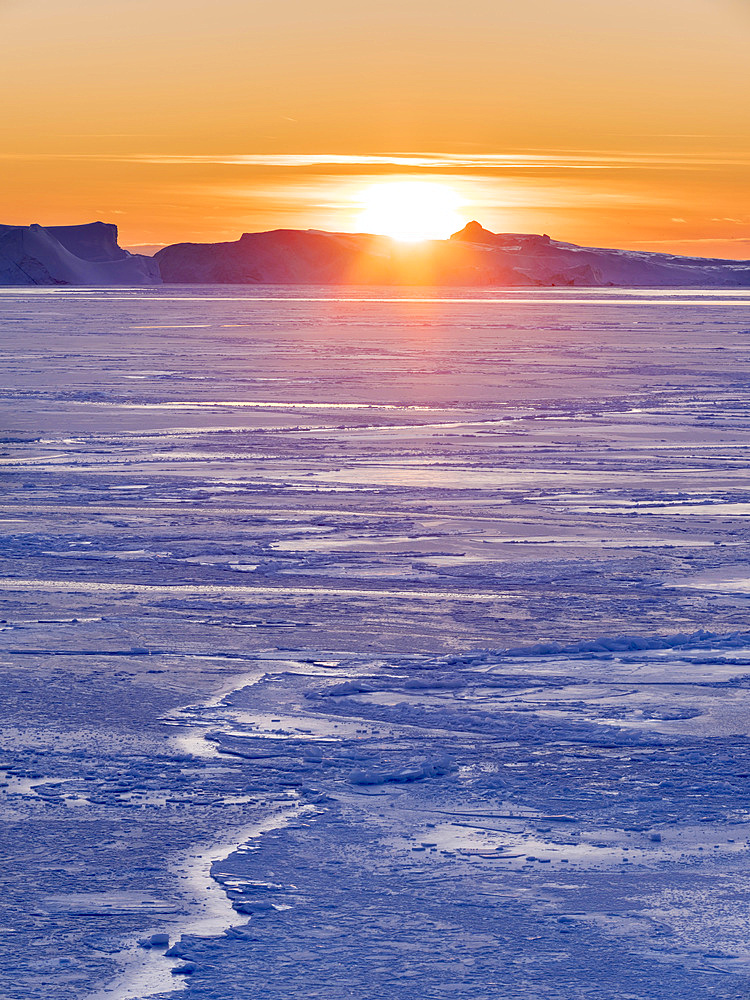 Sunset during winter at the Ilulissat Icefjord, located in the Disko Bay in West Greenland, the Icefjord is part of the UNESCO world heritage. America, North America, Greenland, Denmark