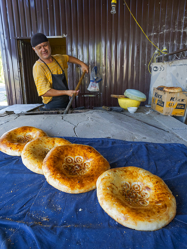 Typical, Traditional bakery making Lepjoschka bread in a clay oven. City Jalal-Abad (Dzhalal-Abad, Djalal-Abat, Jalalabat) in the Fergana Valley close to the border to Uzbekistan. Asia, central Asia, Kyrgyzstan