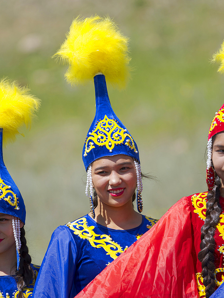 Girls of folk music band posing for visitors and photographers. Folk and Sport festival on the Suusamyr plain commemorating Mr Koshomkul, a sportsman and folk hero of the last century. Asia, central asia, Kyrgyzstan