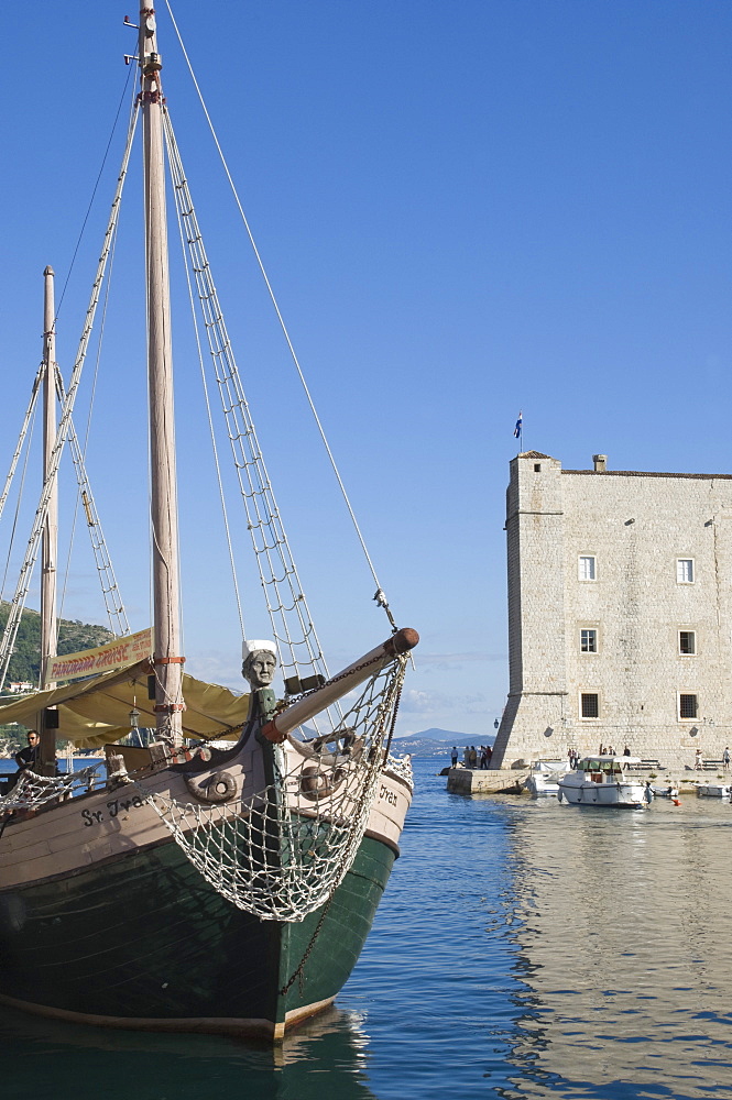 A local tourist boat moored in the old harbour, Old City, Dubrovnik, UNESCO World Heritage Site, Croatia, Europe