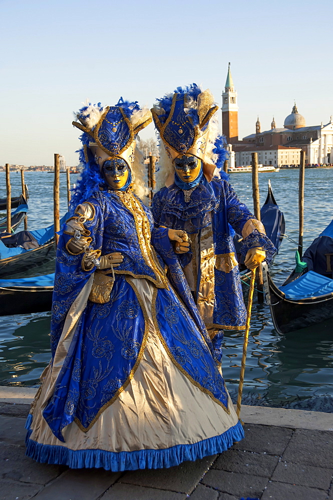 Two ladies in blue and gold masks, Venice Carnival, Venice, UNESCO World Heritage Site, Veneto, Italy, Europe