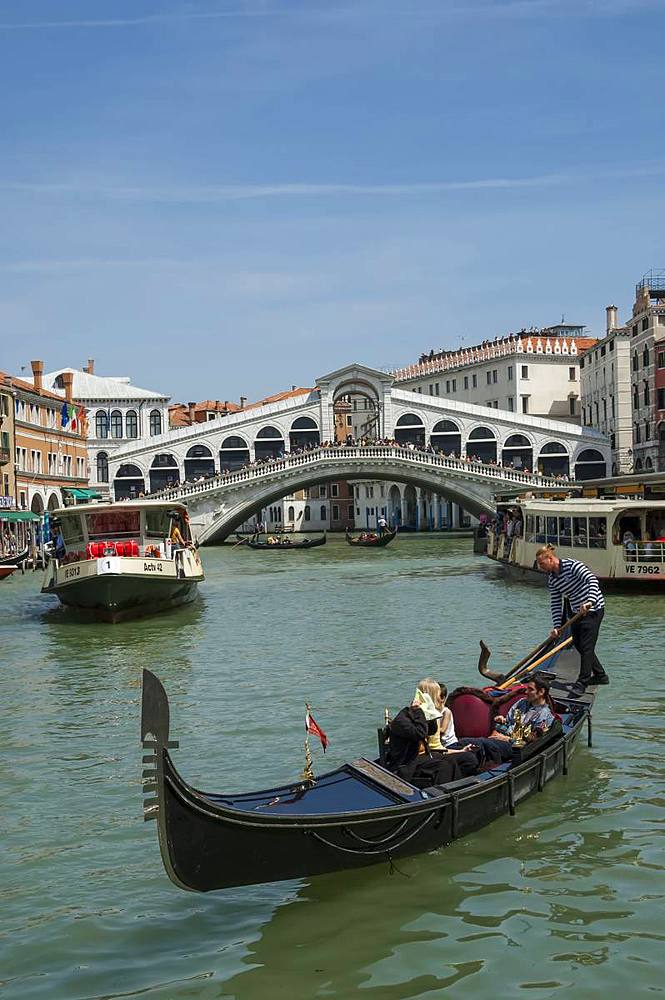 Water bus and gondola on the Grand Canal with the Rialto Bridge in the background, Venice, UNESCO World Heritage Site, Veneto, Italy, Europe