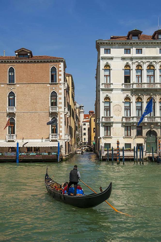 Gondola and gondolier entering a Side canal from the Grand Canal, Venice, UNESCO World Heritage Site, Veneto, Italy, Europe