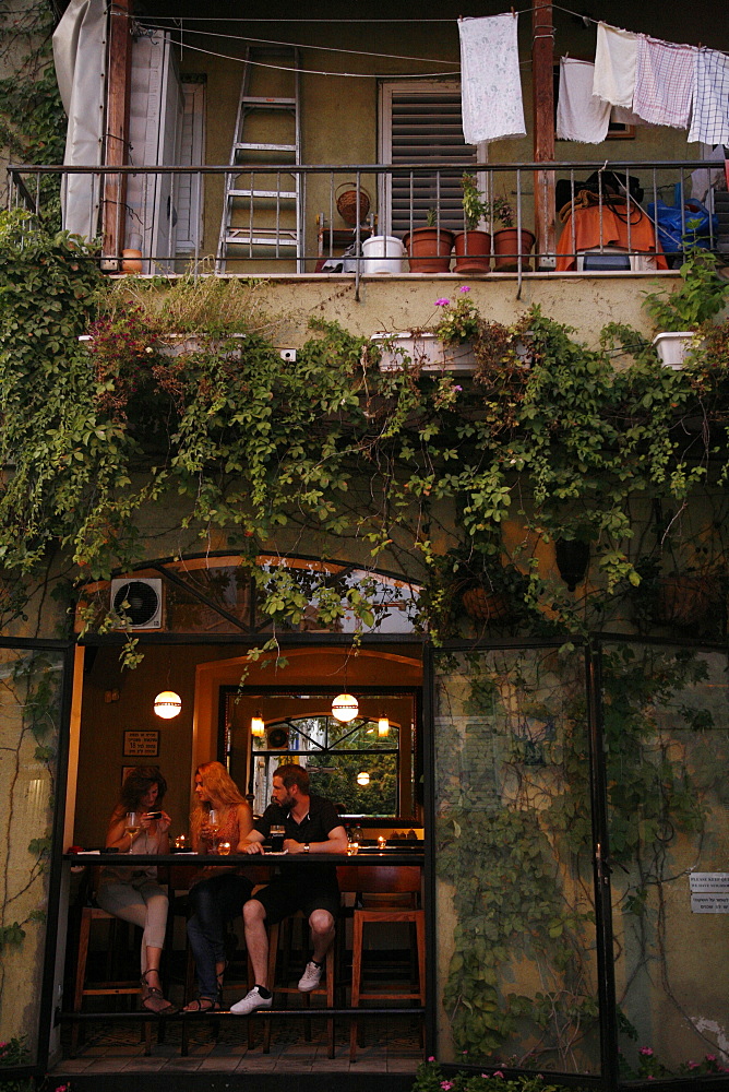 People sitting at a bar in the trendy Neve Tzedek neighbourhood, Tel Aviv, Israel, Middle East