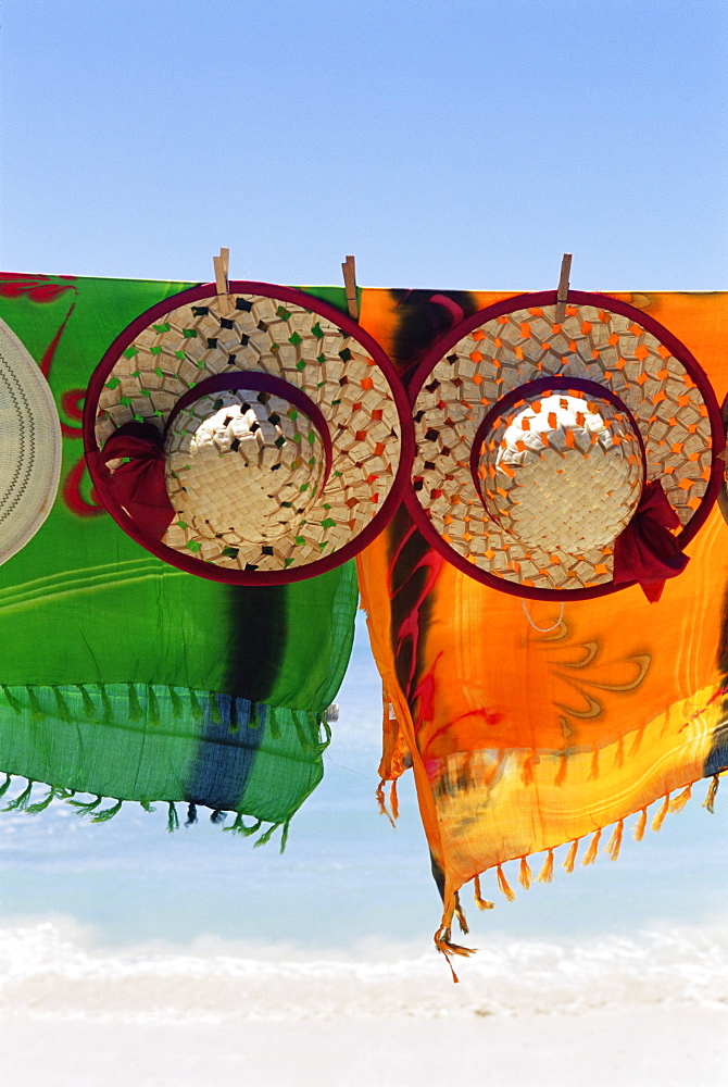 Hats and batiks hanging on a line, Pigeon Point, island of Tobago, West Indies, Caribbean, Central America